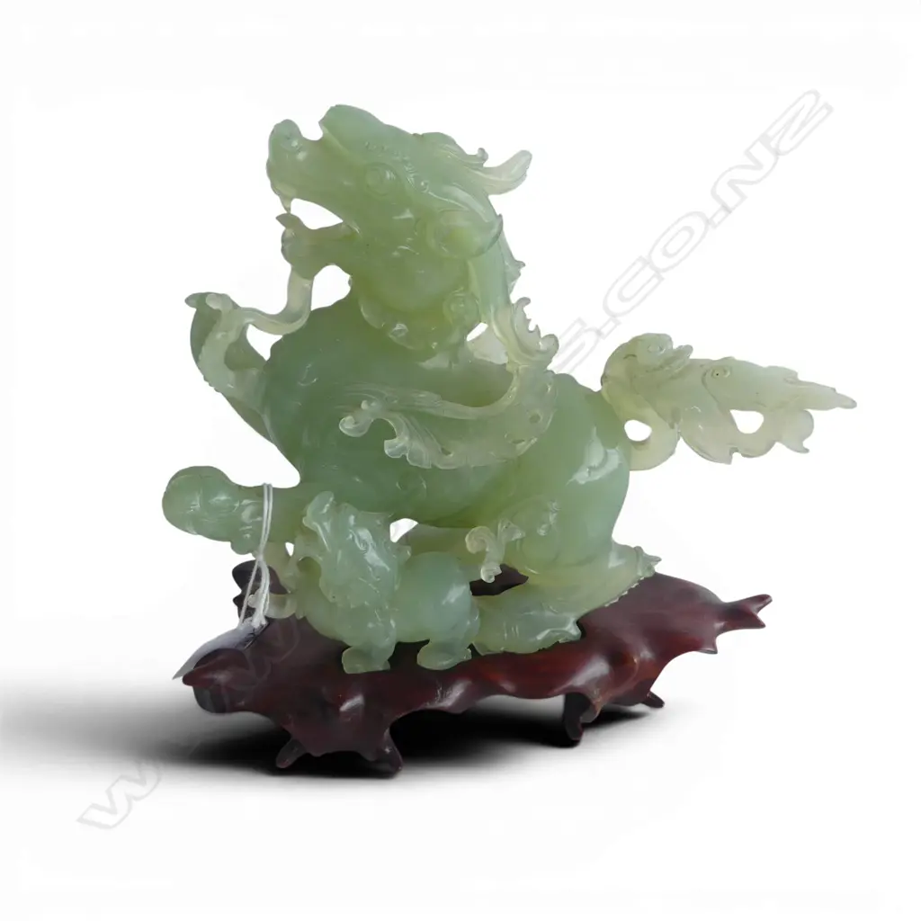 CHINESE PALE GREEN JADE CARVING OF A DRAGON with young the tail broken and restuck etc. ON WOOD STAND. H.180mm Image 1++