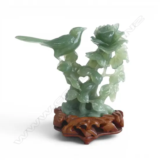 CHINESE PALE GREEN JADE CARVED BIRD ON A LEAFY ROSE BRANCH. Semi translucent mid green tone. On stand. H.205mm.