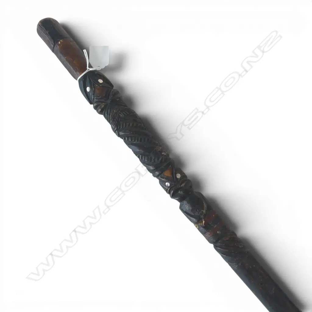 An old Maori carved walking stick (tokotoko) paua inserts. Old repairs. L.830mm.  Image 1++