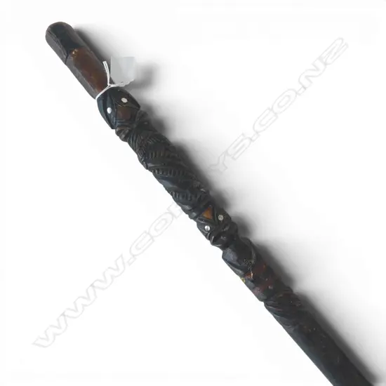 An old Maori carved walking stick (tokotoko) paua inserts. Old repairs. L.830mm. 