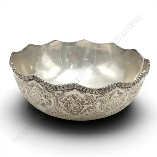 Arabic silver bowl ornate scrolling engraved designs. Applied shaped rim. Impressed marks. Dia.185mm. 363gms