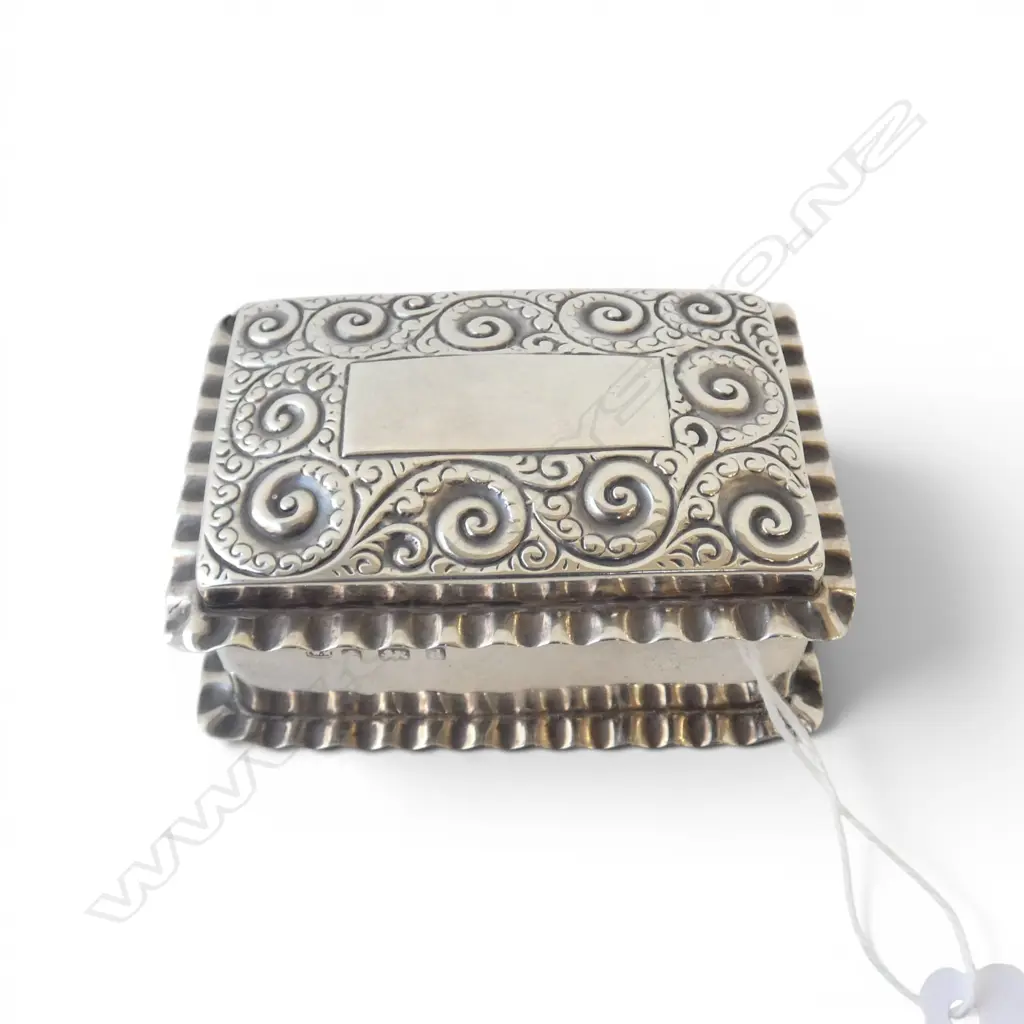 # An Edwardian silver small vanity box, scroll embossed lid. Birmingham 1903 by William Neal. 42gms. Image 1++
