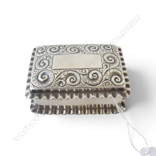 # An Edwardian silver small vanity box, scroll embossed lid. Birmingham 1903 by William Neal. 42gms.