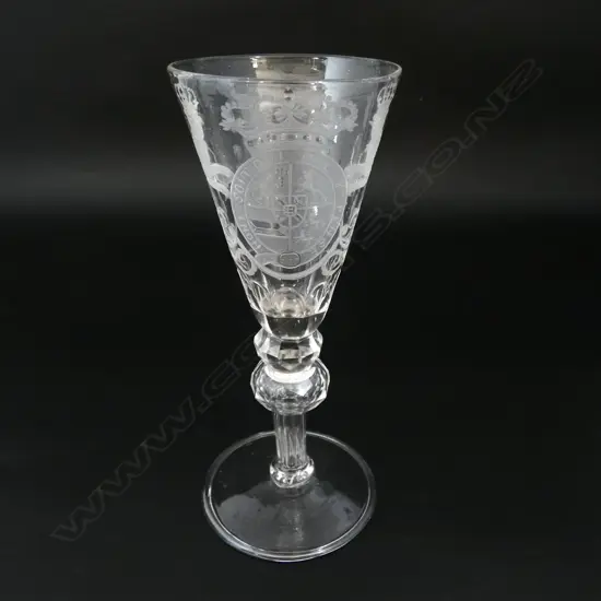 An 18thC soda drinking glass engraved with the British coat of arms double faceted knopped hollow stem wide spreading foot. H.182mm.