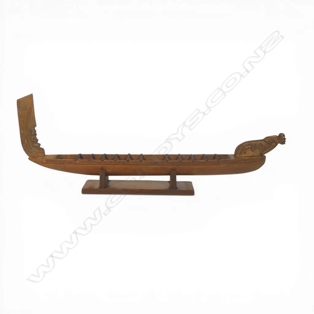 A mid/late 20thC Māori native carved wood model waka on stand, Image 1++