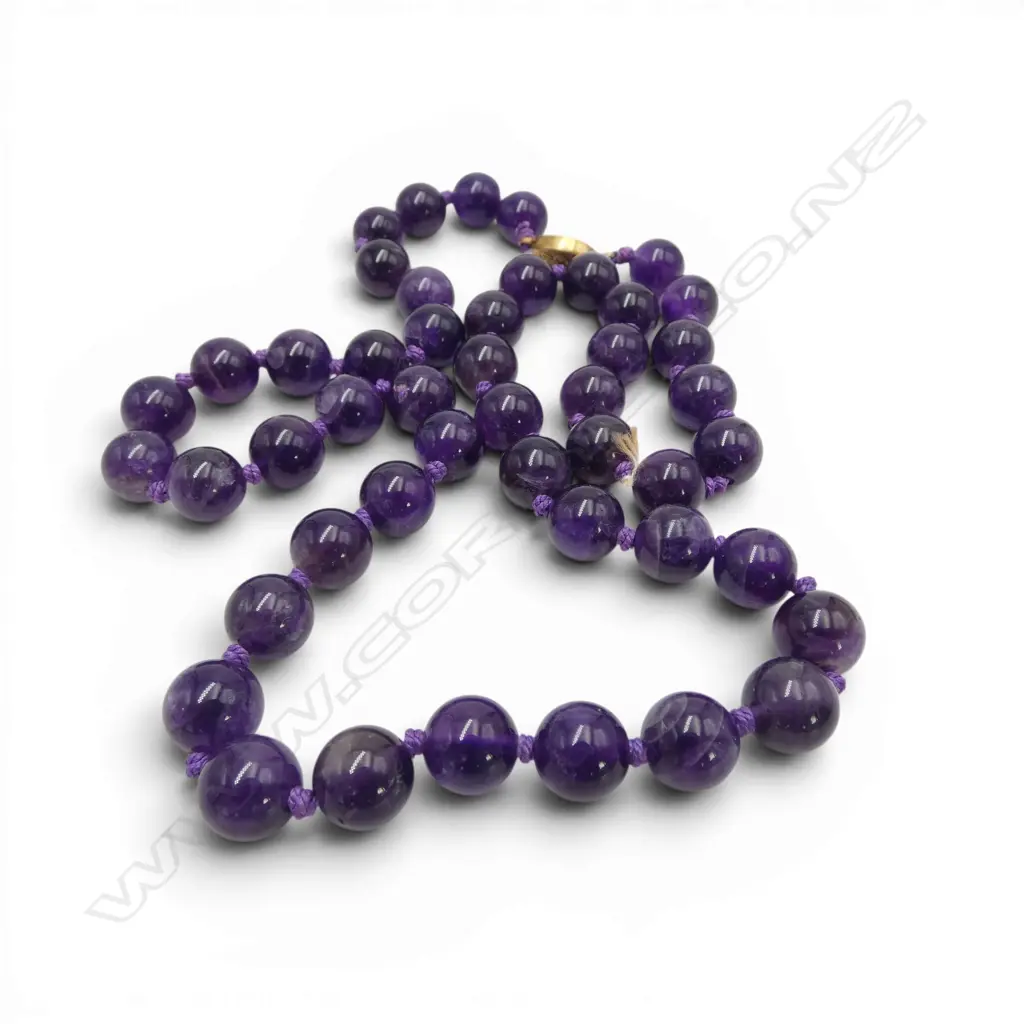 A vintage strand of uniformed polished amethyst beads fitted with fillagree silver gilt clasp. L.620mm Image 1++