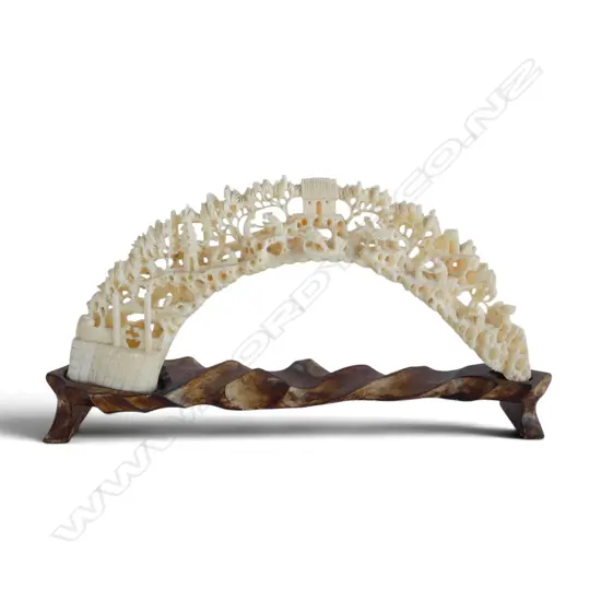 Fine intricately carved vintage carved hippo tusk landscape bridge with figures. L.225mm. On stand. Repair to bridge.
