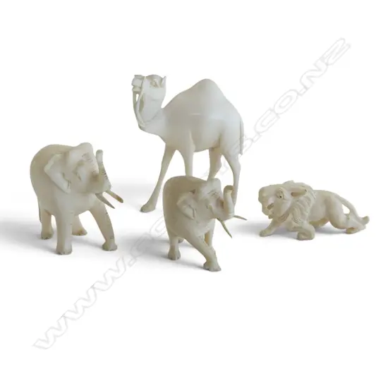 4 CARVED IVORY  ANIMALS. Lion + 2 elephants + camel H.65mm