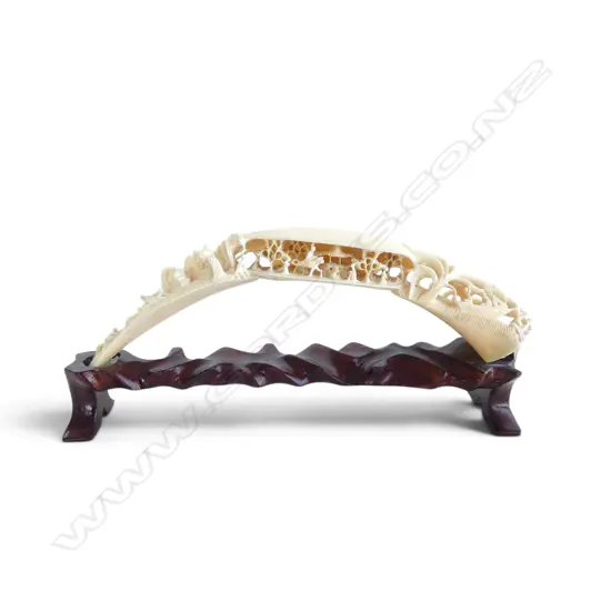 Finely carved vintage carved hippo tusk dream shell bridge with figures. L.240mm. On stand.