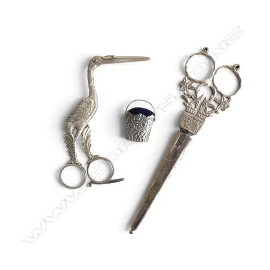 3 SEWING UTENSILS; CRANE FORM CLAMP w. wrapped child to inside, PR SCISSORS in STG SILVER CASE 9gms & SILVER PIN CUSHION