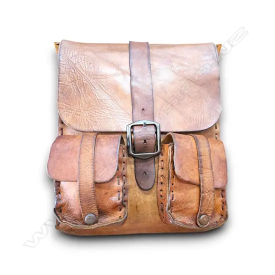 VINTAGE LEATHER BAG FOLD-OVER FLAP W A CENTRAL BUCKLE STRAP, TWO FRONT UTILITY POCKETS W HEAVY HAND-STITCHE 440 mm