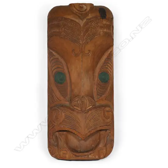 Mid/late 20thC Māori carved gable mask, green staining to the double spiral carved eyes. H.450mm.