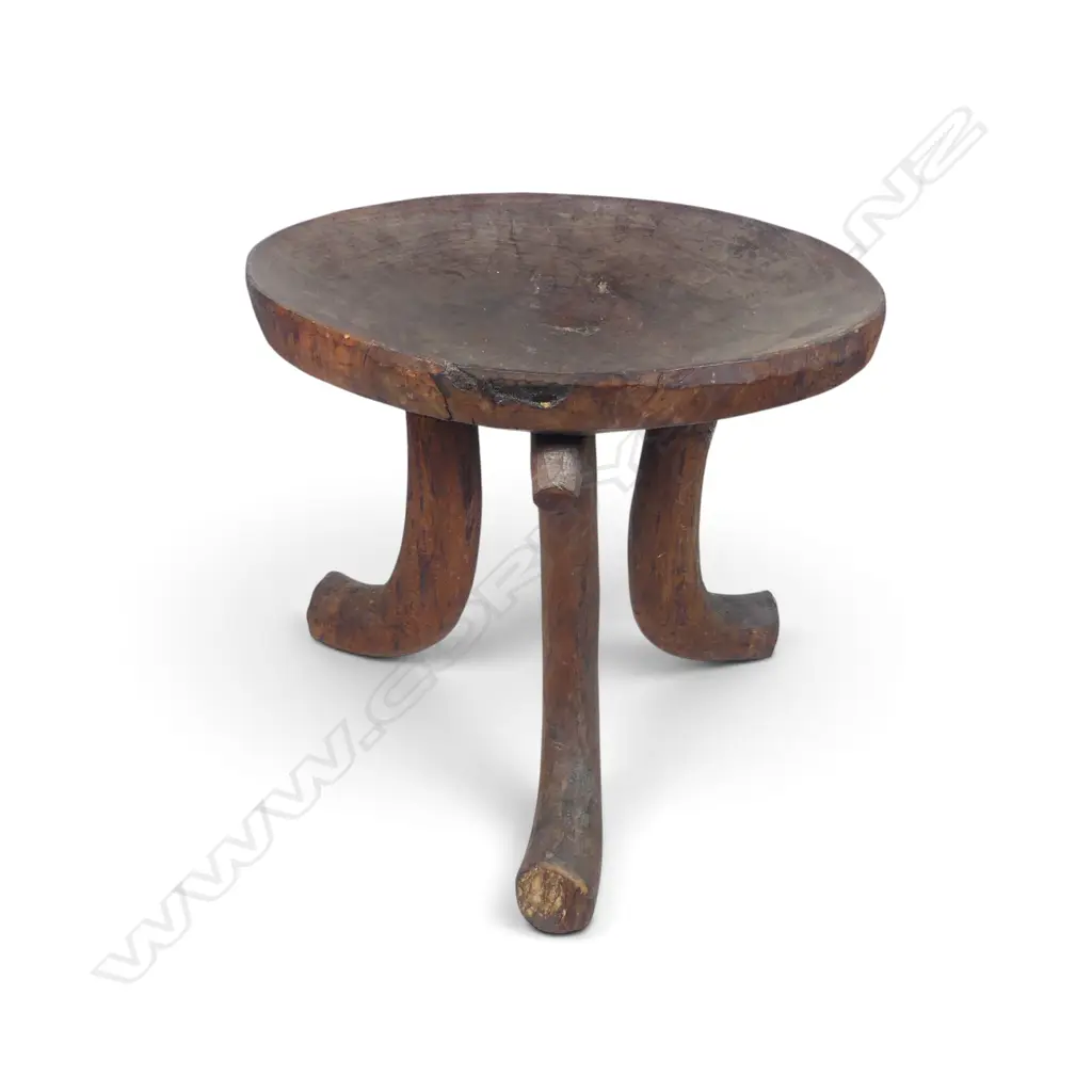 ETHIOPIAN (JIMMA PEOPLE) CARVED TRIPOD WOODEN STOOL WITH DISTINCT HORN SHAPED CURVED LEGS.H.390MM DIA 440MM Image 1++