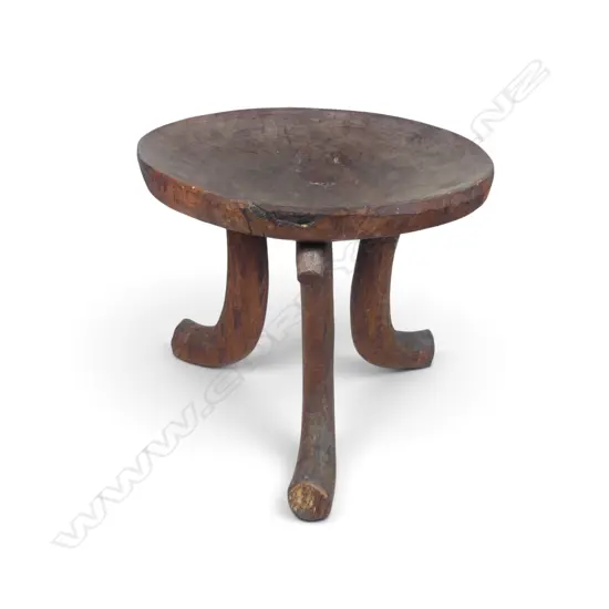 ETHIOPIAN (JIMMA PEOPLE) CARVED TRIPOD WOODEN STOOL WITH DISTINCT HORN SHAPED CURVED LEGS.H.390MM DIA 440MM
