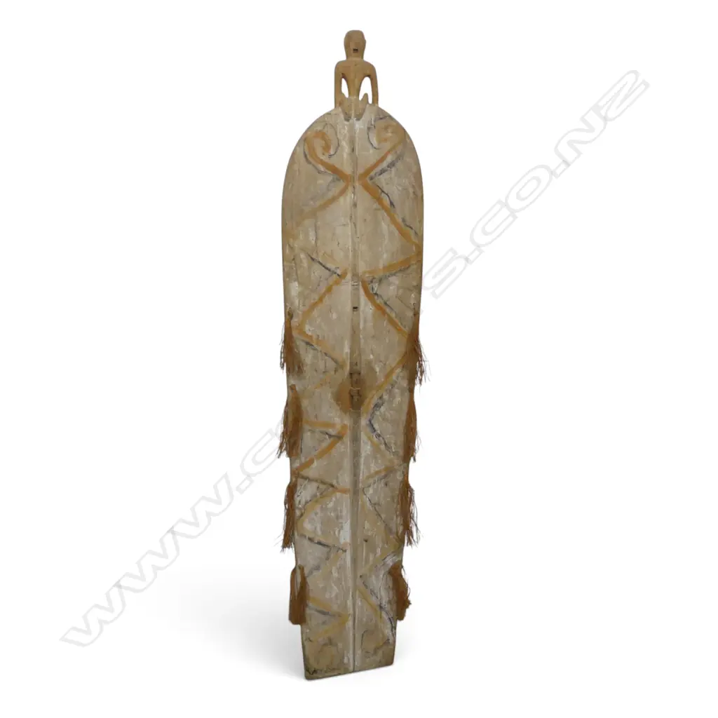 CARVED WOODEN ASMAT SHIELD WITH ANCESTOR FIGURE HANDLE AND OCHRE PIGMENT, SOUTH PAPUA.H.1700 X 360MM Image 1++