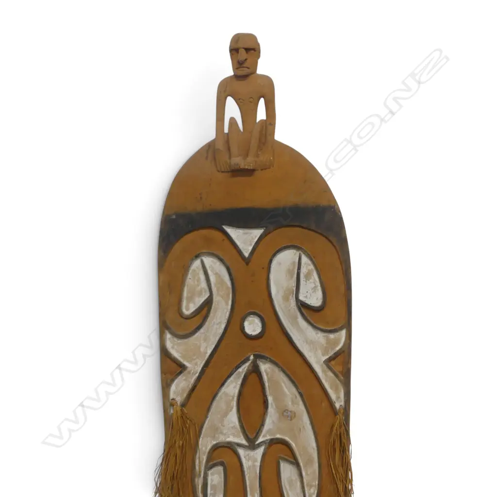 CARVED WOODEN ASMAT SHIELD WITH ANCESTOR FIGURE HANDLE AND OCHRE PIGMENT, SOUTH PAPUA.H.1700 X 360MM Image 1++