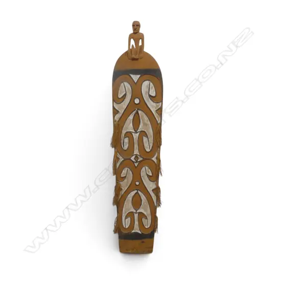 CARVED WOODEN ASMAT SHIELD WITH ANCESTOR FIGURE HANDLE AND OCHRE PIGMENT, SOUTH PAPUA.H.1700 X 360MM
