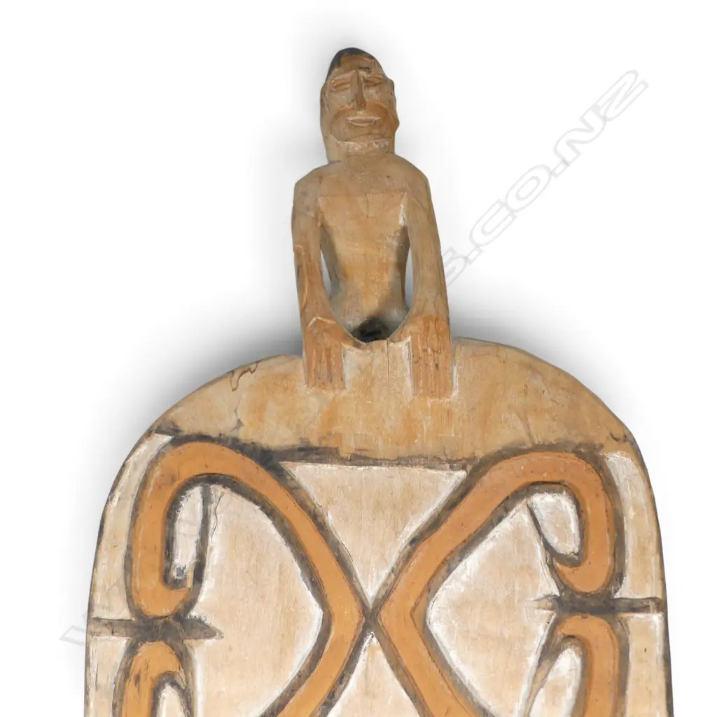 CARVED WOODEN ASMAT SHIELD WITH ANCESTOR FIGURE HANDLE AND OCHRE PIGMENTS, SOUTH PAPUA.H.900 X 360MM Image 1++