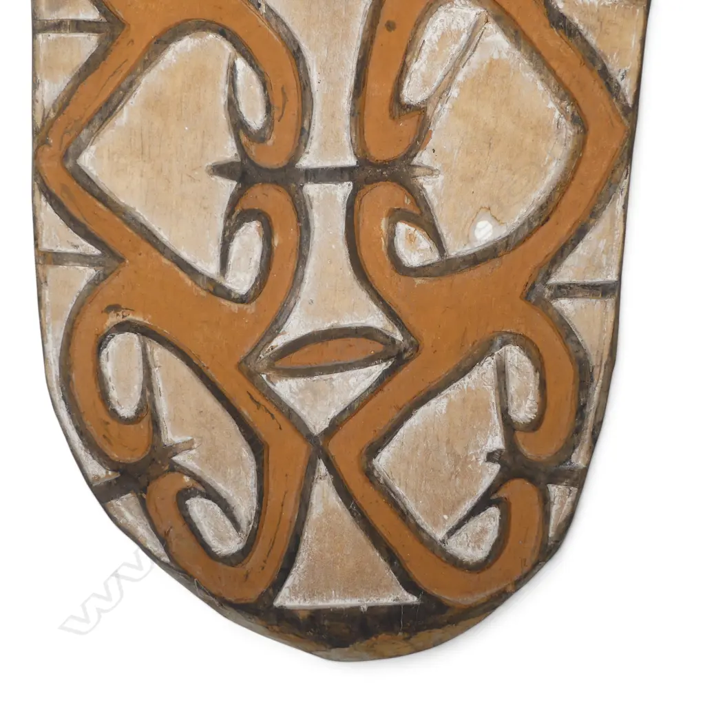 CARVED WOODEN ASMAT SHIELD WITH ANCESTOR FIGURE HANDLE AND OCHRE PIGMENTS, SOUTH PAPUA.H.900 X 360MM Image 1++