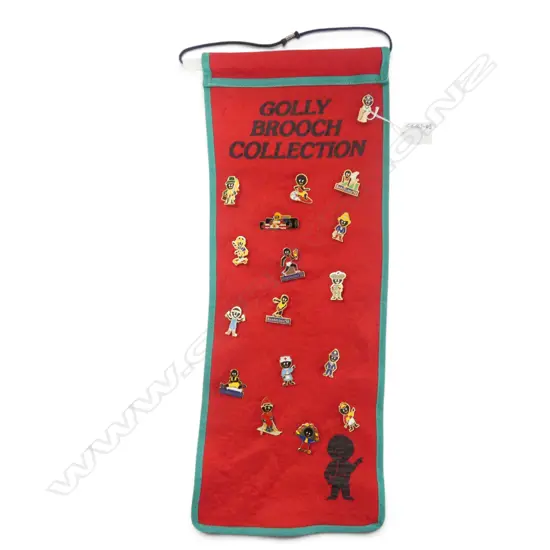 'GOLLY BROOCH COLLECTION' on red felt wall mounted backing
