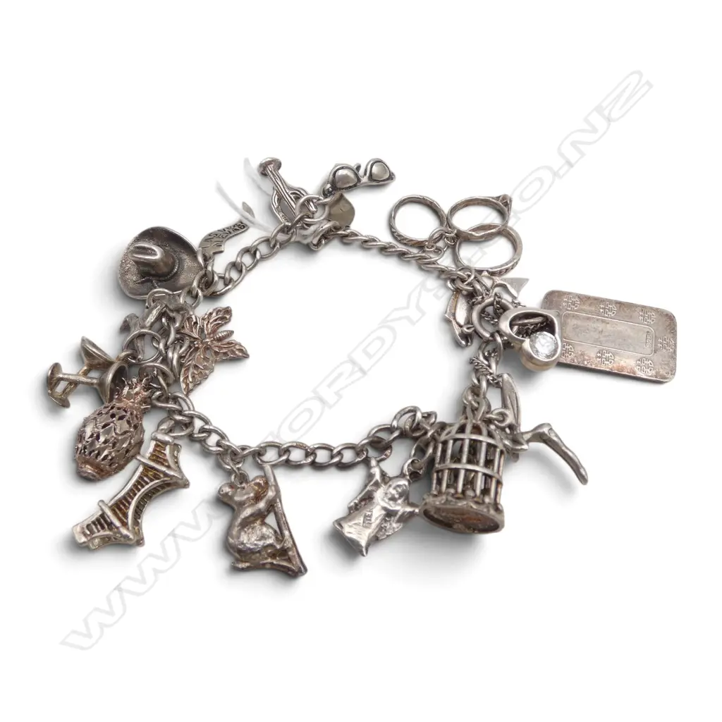 STG SILVER CHARM BRACELET w. asst. mostly silver charms 35gms Image 1++