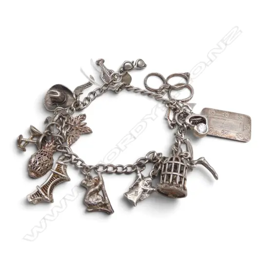 STG SILVER CHARM BRACELET w. asst. mostly silver charms 35gms