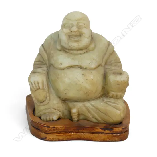 CARVED LIGHT GREEN SOAPSTONE HOTEI LAUGHING BUDDHA WITH BROWN PATINA SEATED ON A WOODEN BASE. H.160MM