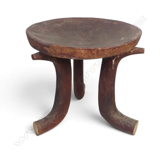 ETHIOPIAN (JIMMA PEOPLE) CARVED TRIPOD WOODEN STOOL WITH DISTINCT HORN SHAPED CURVED LEGS.H.370MM DIA 390MM