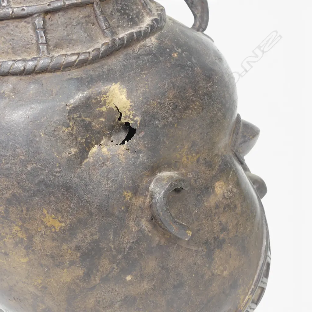 WEST AFRICAN STYLIZED DARK BRONZED METAL HEAD WITH GEOMETRIC FACIAL MARKINGS & PROMINENTS EYES,DENT ON LEFT SIDE.H.333MM Image 1++