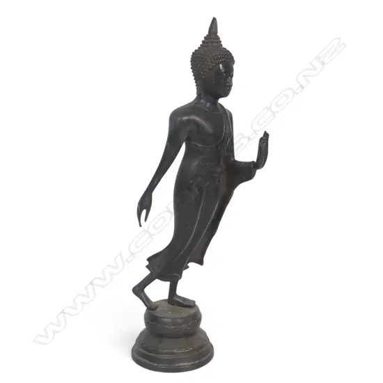 GRACEFUL DARK BRONZED THAI WALKING BUDDHA WITH ONE HAND RAISED FEARLESSNESSLY, STAMP TO THE BASE.H.400MM
