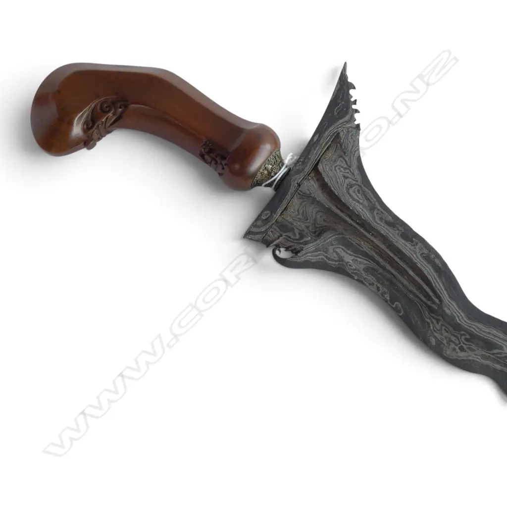 An Indonesian kriss with exotic wood handle and scabbard  w brass . Wavy Damascus steel blade. L.520mm. In green velvet cover Image 1++
