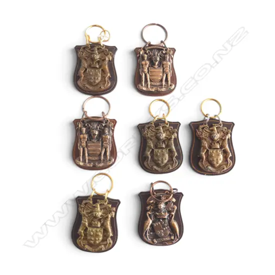 7 BRASS 'GRAHAM', 'CAMERON' & 'FRASER' ARMORIALS ON LEATHER SHIELDS H.75mm