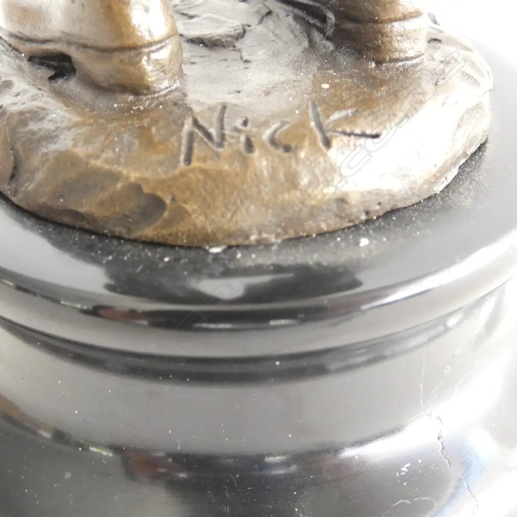 Contemporary bronze 'The Smoker Boy' signed 'Nick' on black marble base. H.215mm. Shielding the flame with his hat. Image 1++