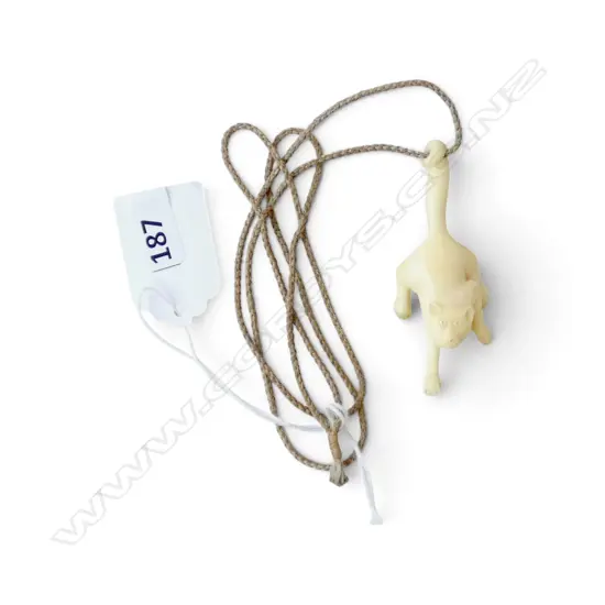 BONE CARVED PENDANT OF A PROWLING CAT. L.65mm