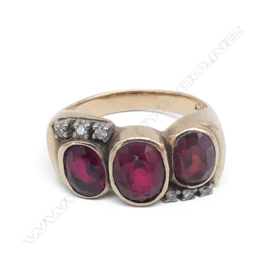 9ct Gold and ONE facet cut garnet with two red stones ring with six small diamonds. 6.48gms
