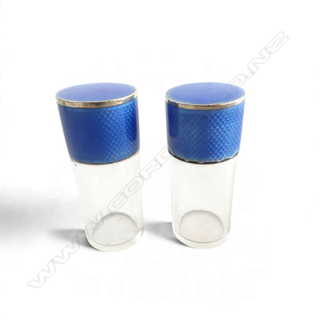 Pair of Asprey & Co Ltd (London 1910) BLUE ENAMELLED SILVER TOP GLASS VANITY BOTTLES minor loss to edge of one. H.60mm. Image 1++