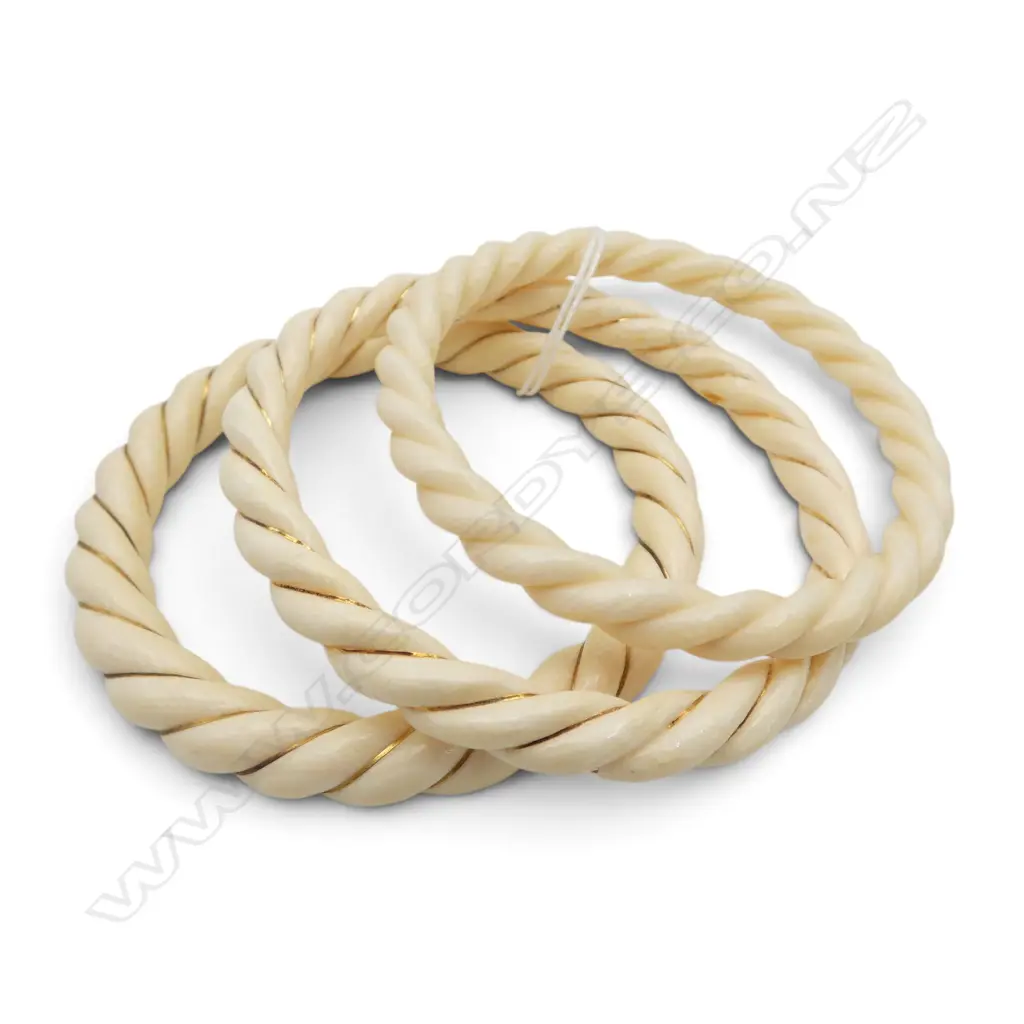 THREE IVORY TWIST BANGLES TWO WITH FINE GOLD BANDING Image 1++