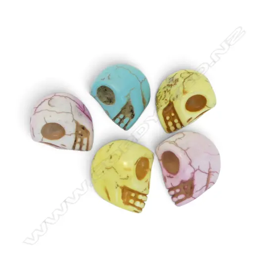 FIVE HOWLITE DYED STONE SKULLS
