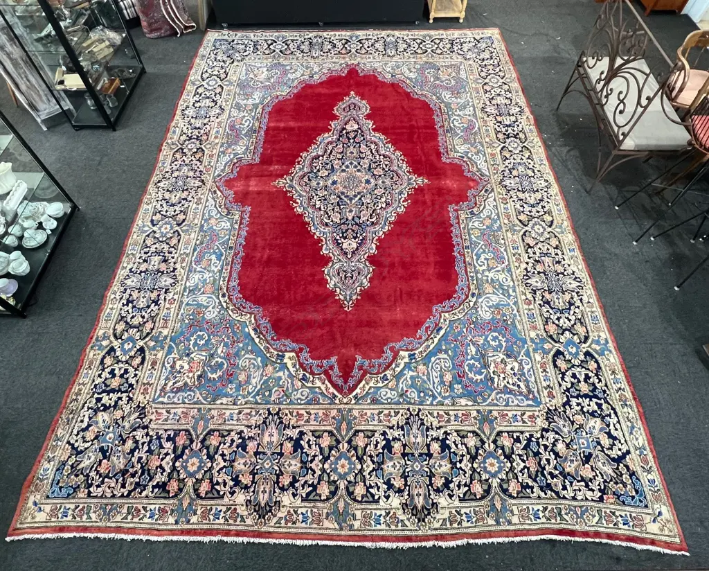 Very large Persian Kerman hand knotted carpet w curvilinear tendril design. Red ground. 5050 x3500mm. Some threads bare Image 1++