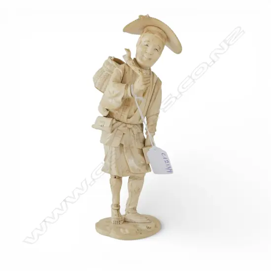 JAPANESE IVORY FIGURE; MAN CARRYING SACK OVER SHOULDER H.225mm SIGNED TO BASE