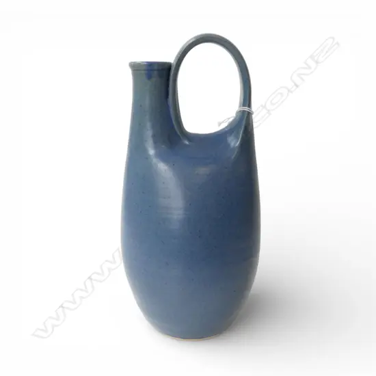 RICHARD CADNESS LOOP HANDLE BLUE GLAZE JUG. Impressed potter's mark. H.300mm