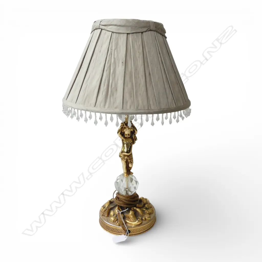 A DECORATIVE GILDED TABLE LAMP WITH CHERUB SUPPORTING A BEADED SHADE 520 mm (H) Image 1++