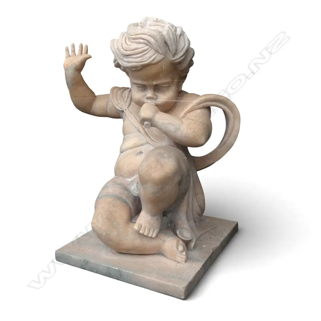 Large carved orange marble statue of a cherub with trumpet, trumpet damaged. H800mm Image 1++