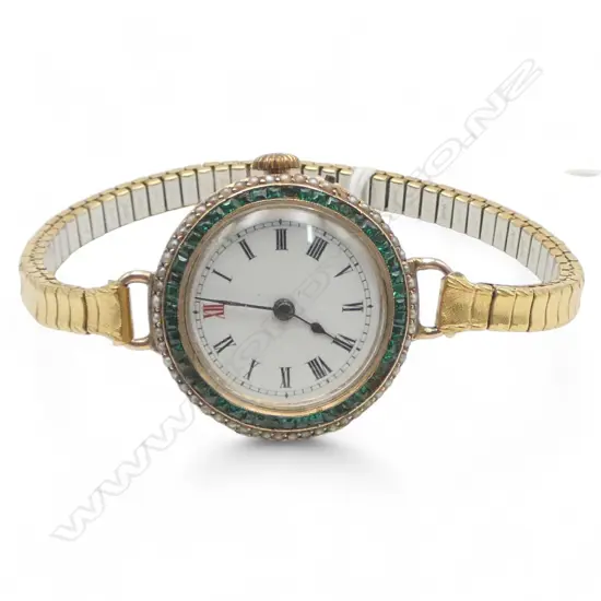 C.1910 9ct EMERALD & SEED PEARL (1 missing) some emeralds damaged SWISS ladies WRIST WATCH later plated strap. Running