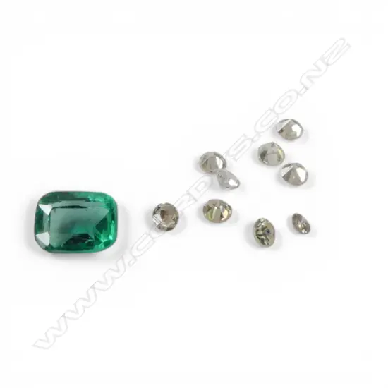 FINE QUALITY COLUMBIAN EMERALD 4.4 x 3.3mm. approx 0.40ct plus 9 small diamonds
