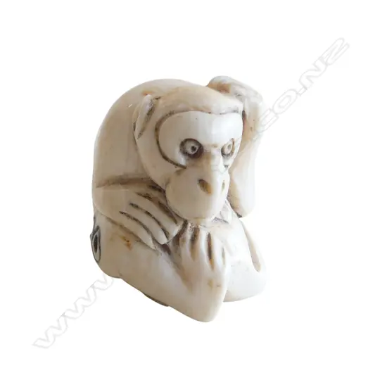 OLD JAPANESE CARVED IVORY NETSUKE of a seated monkey  signed.