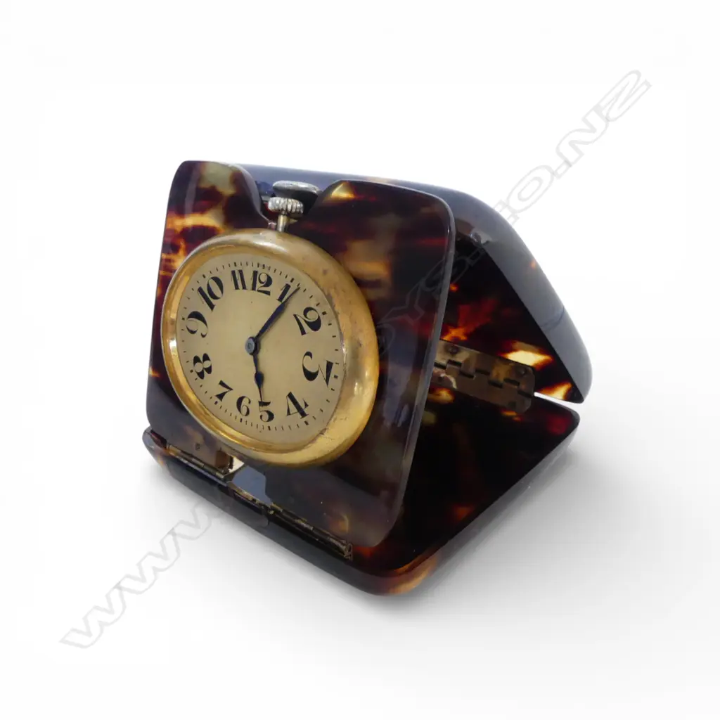 SWISS MADE TRAVELLING CLOCK running. Gilt cased in early tortoiseshell plastic outer case, no glass Image 1++