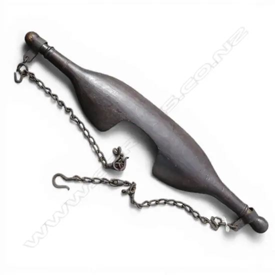 # A 19thC fruitwood human yolk with chains