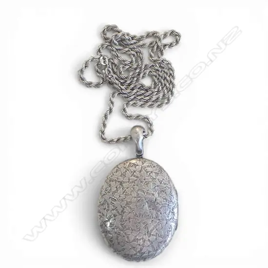 # A large silver engraved locket on rope twist chain 42gms