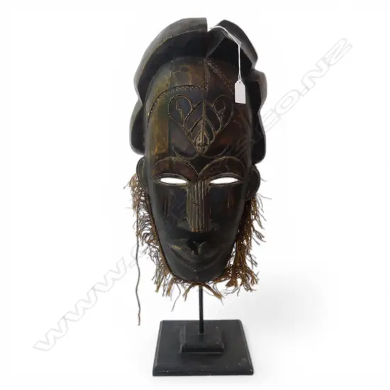AFRICAN CARVED WOOD MASK with fibre beard on metal stand. H.610mm
